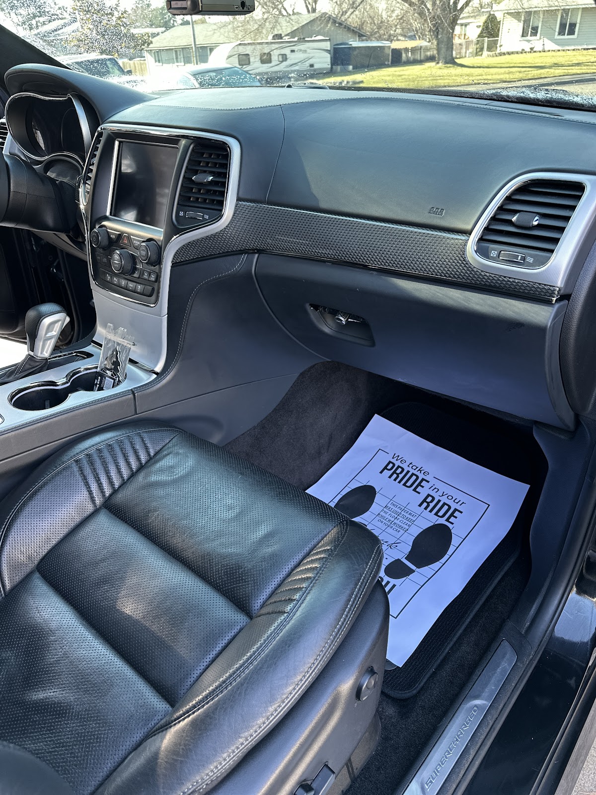 Detailed Jeep interior with the We Take Pride in Your Ride floor protector