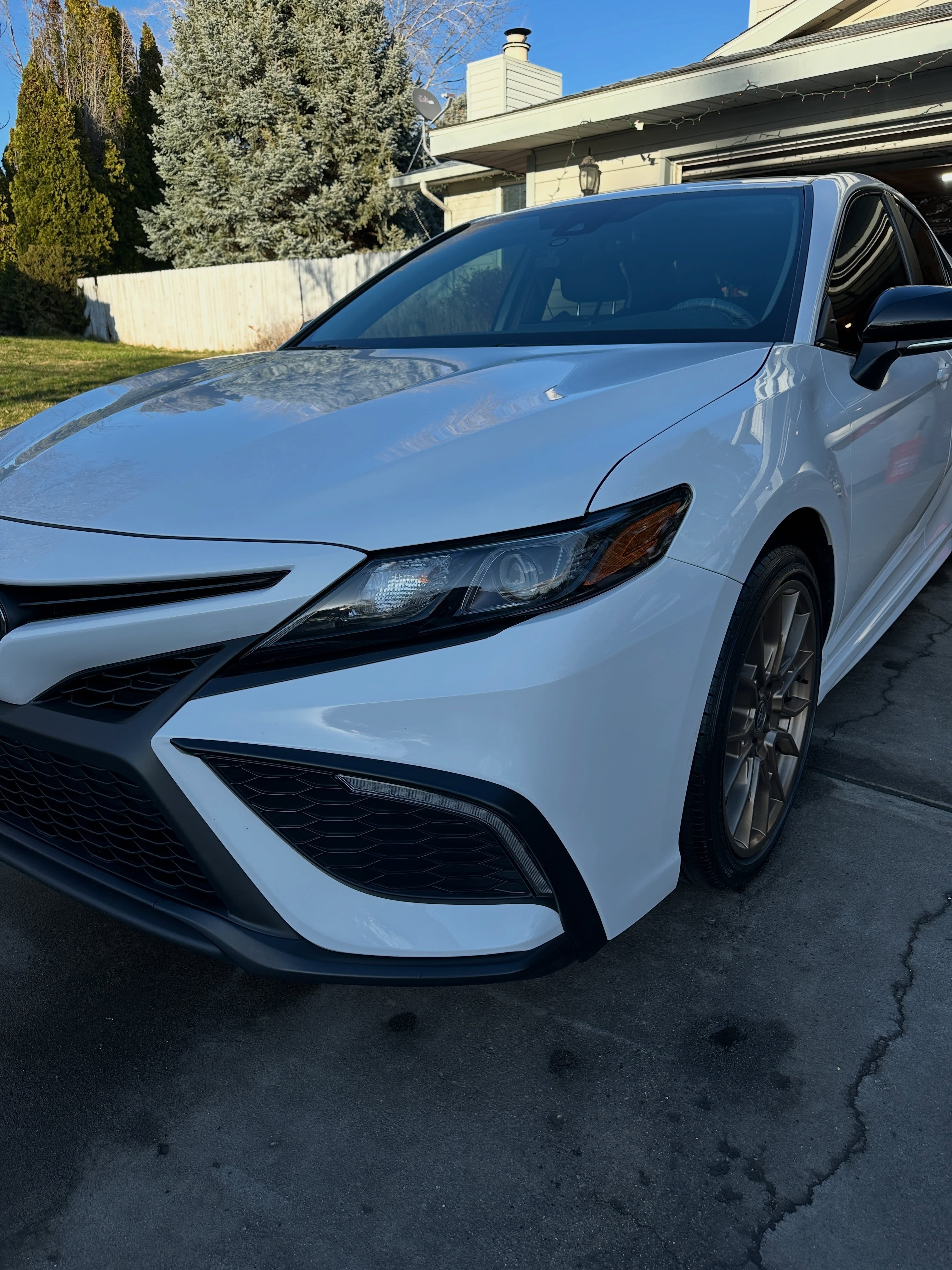Glossy white Toyota Camry detailed in a Tri-Cities driveway