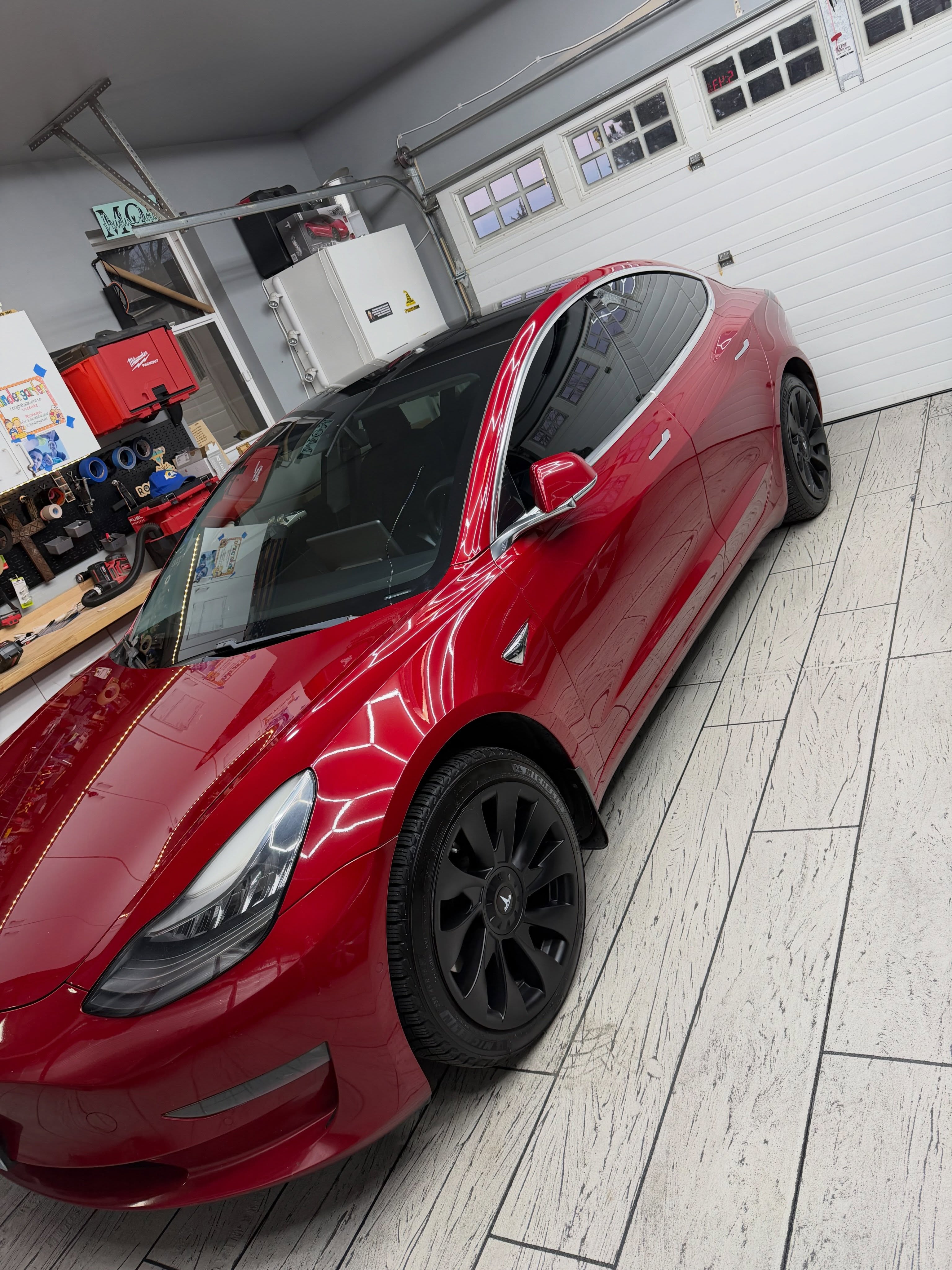 Candy-red Tesla Model 3 with a flawless, freshly detailed gloss finish